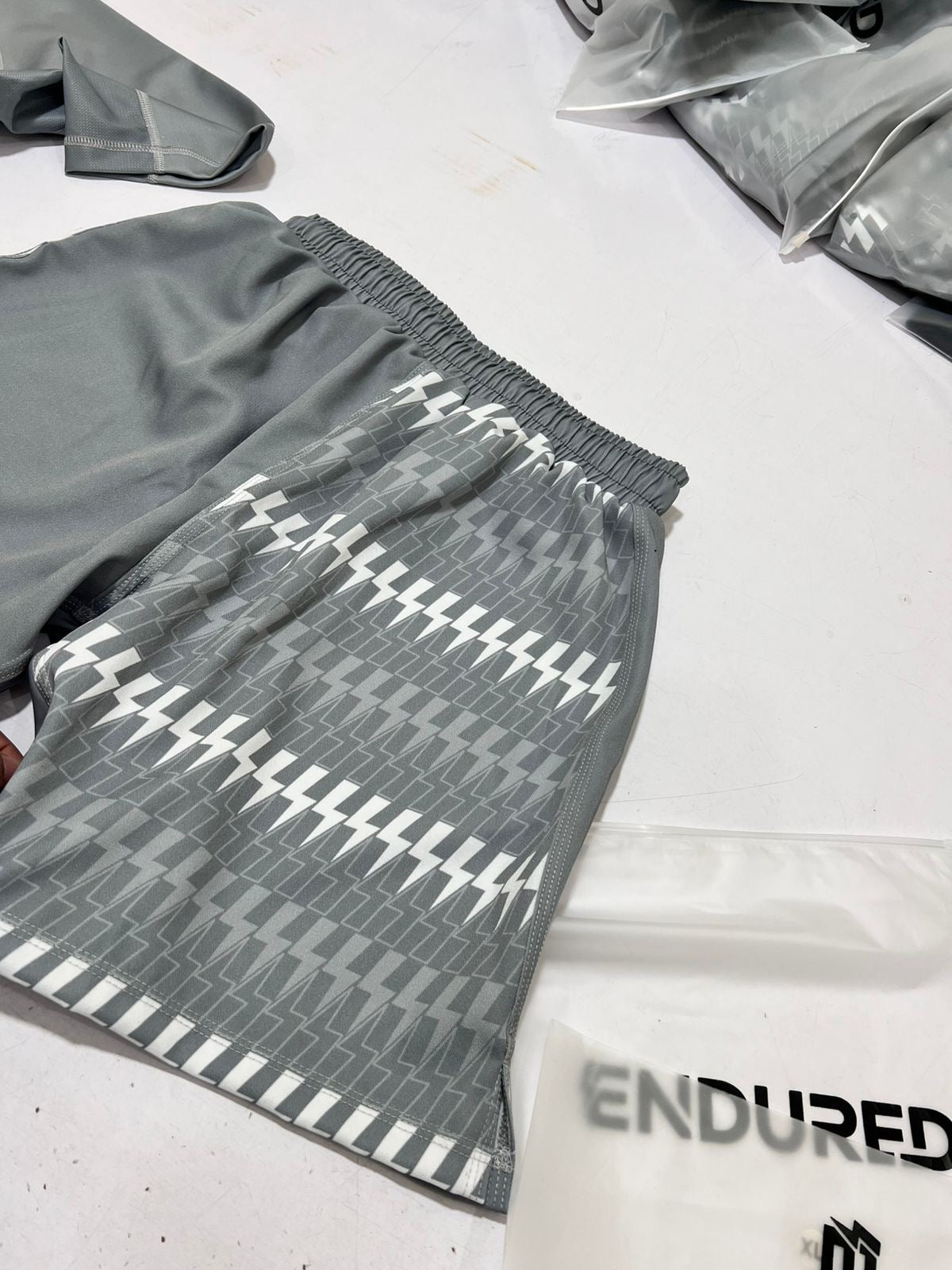 Grey shorts with repeated lighting bolt