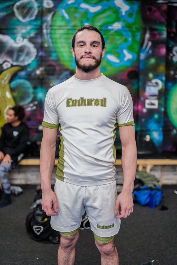 Cream and green block logo rashguard