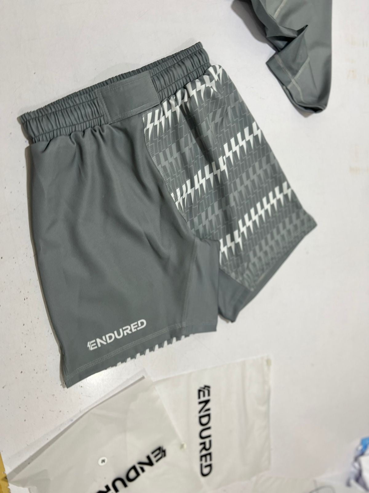 Grey shorts with repeated lighting bolt